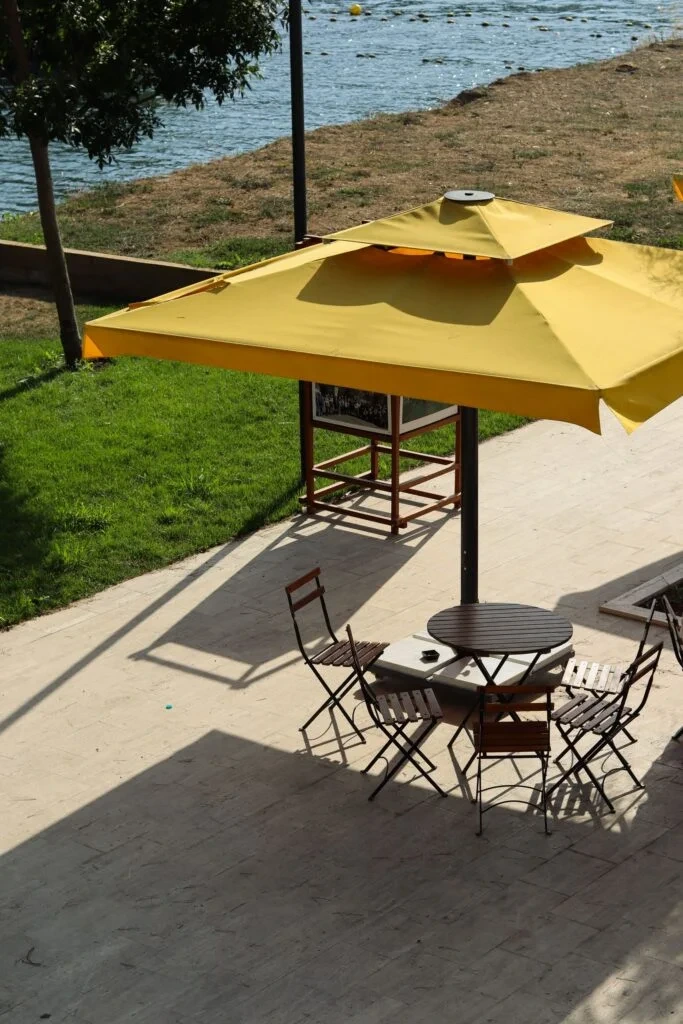 An outside sitting area with yellow ambrella